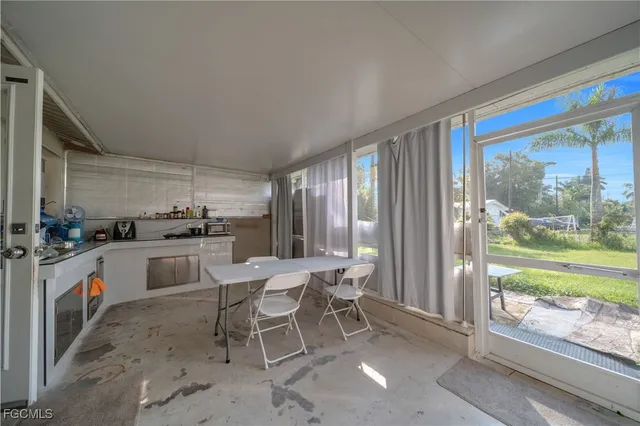a kitchen with a sink and chairs