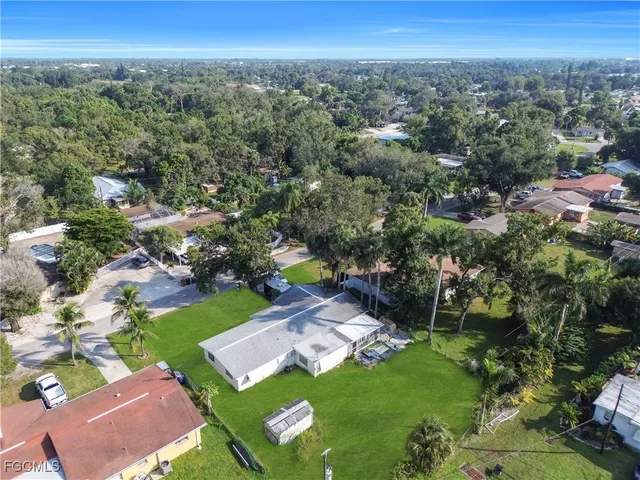 an aerial view of green landscape with trees houses and mountain view
