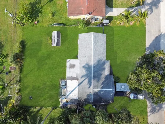 an aerial view of a house with a yard basket ball court and outdoor seating