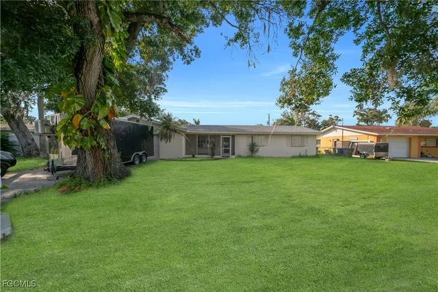 a front view of house with a garden