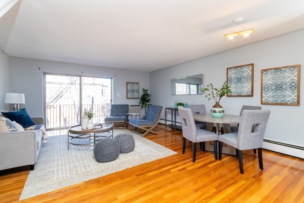 57 St Paul Street, Unit 19 Brookline, MA 02446 - Photo 1 of 23 a living room with furniture a rug a lamp and a window