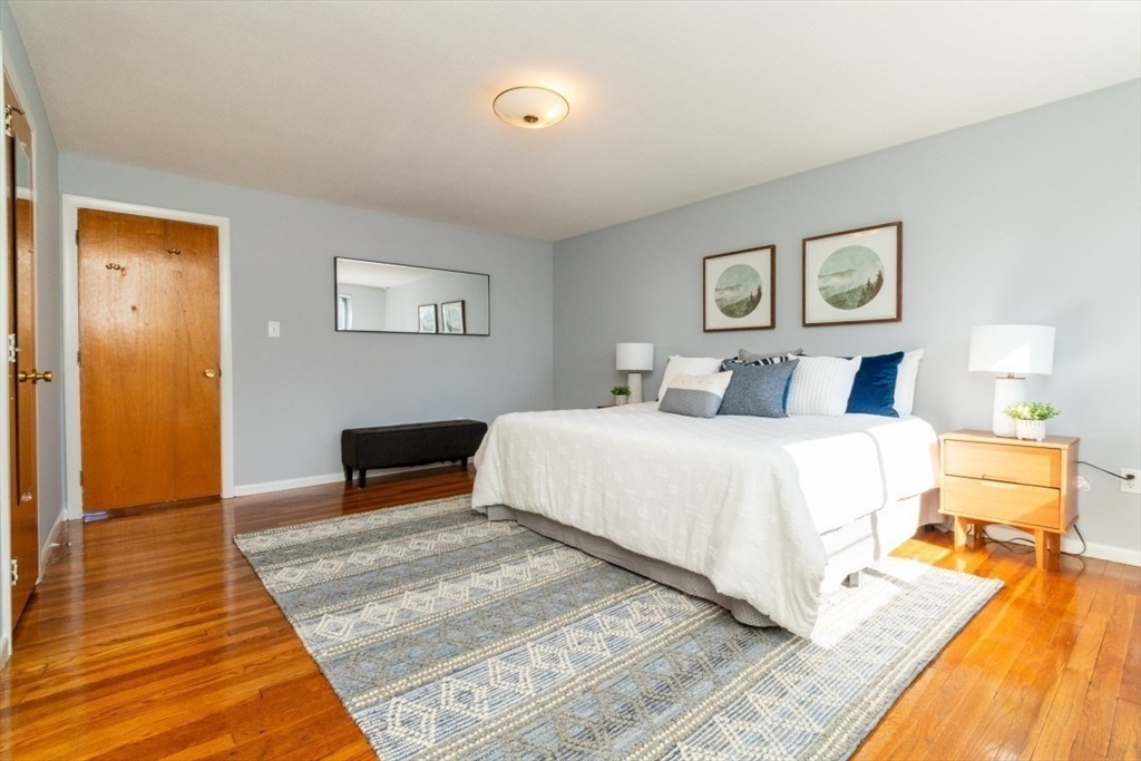 57 St Paul Street, Unit 19 Brookline, MA 02446 - Photo 11 of 23 a bedroom with a bed and wooden floor