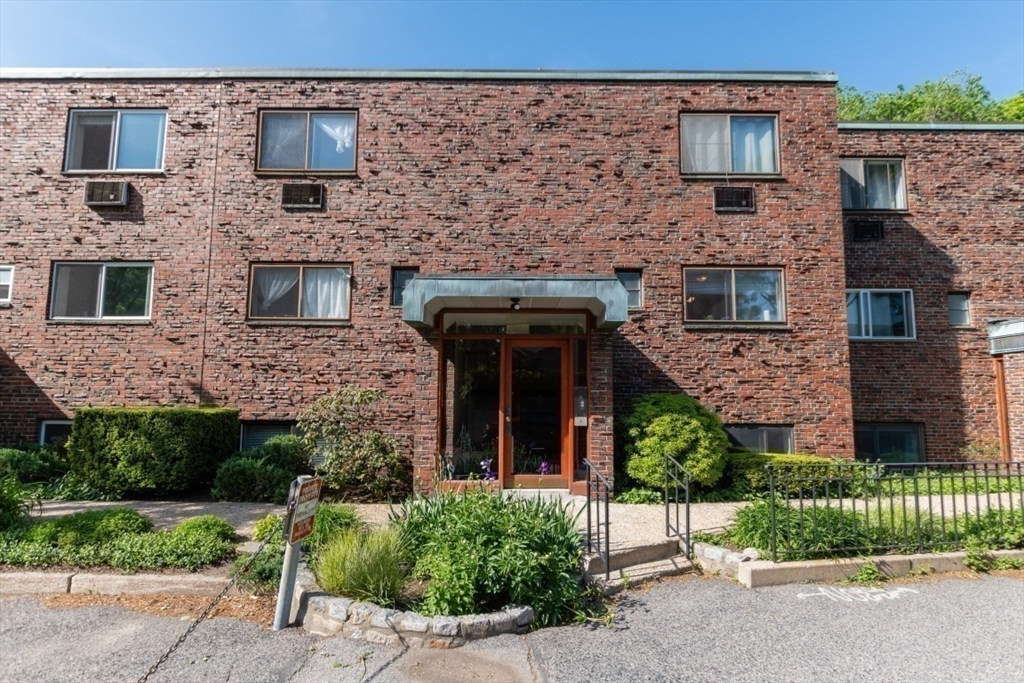 57 St Paul Street, Unit 19 Brookline, MA 02446 - Photo 14 of 23 a front view of a house with a garden