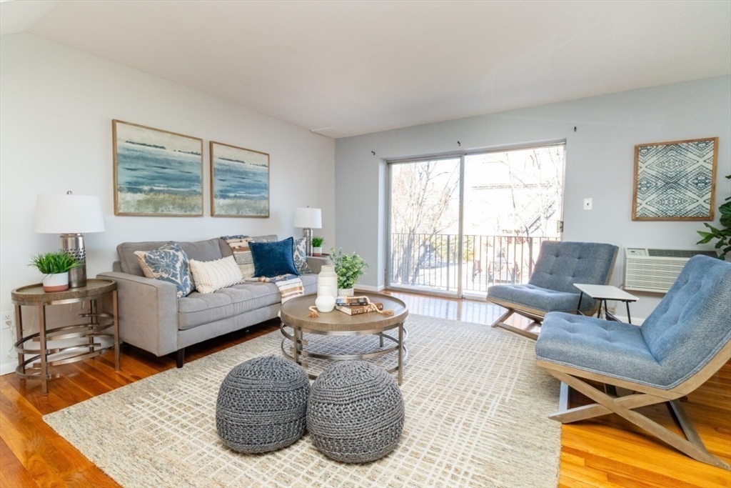 57 St Paul Street, Unit 19 Brookline, MA 02446 - Photo 2 of 23 a living room with furniture and a large window
