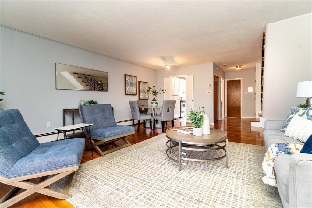 57 St Paul Street, Unit 19 Brookline, MA 02446 - Photo 3 of 23 a living room with furniture and wooden floor