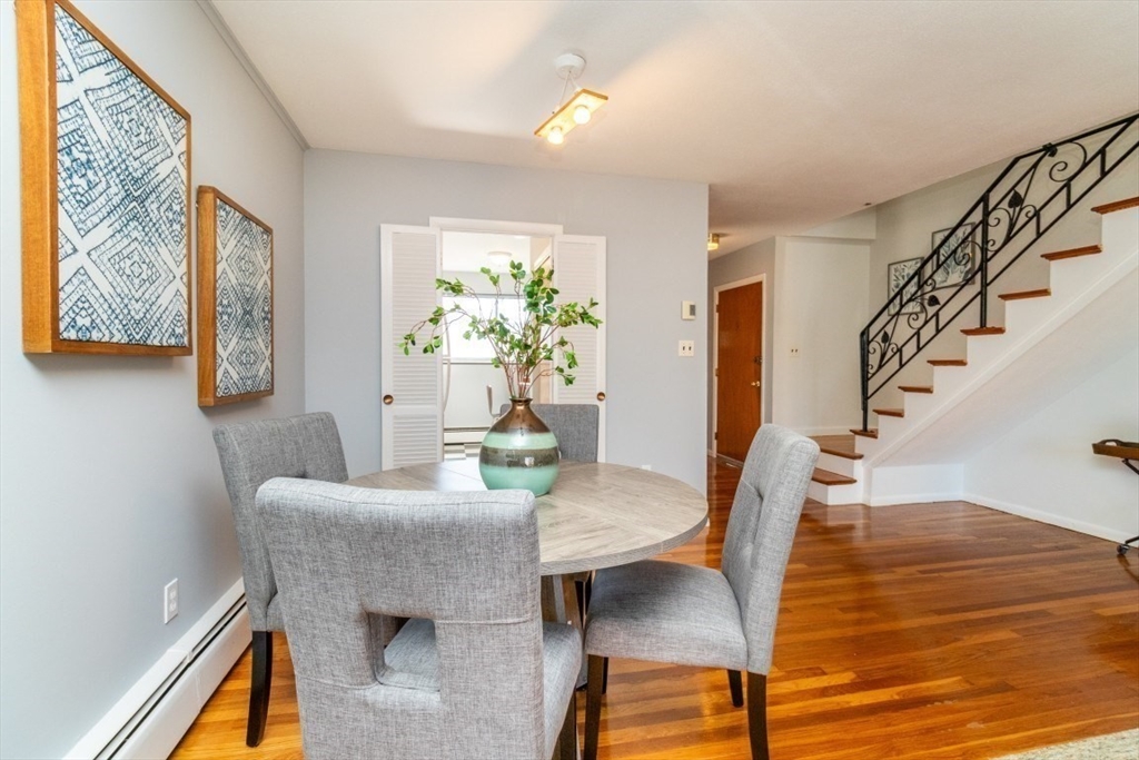 57 St Paul Street, Unit 19 Brookline, MA 02446 - Photo 6 of 23 a dining room with furniture and wooden floor