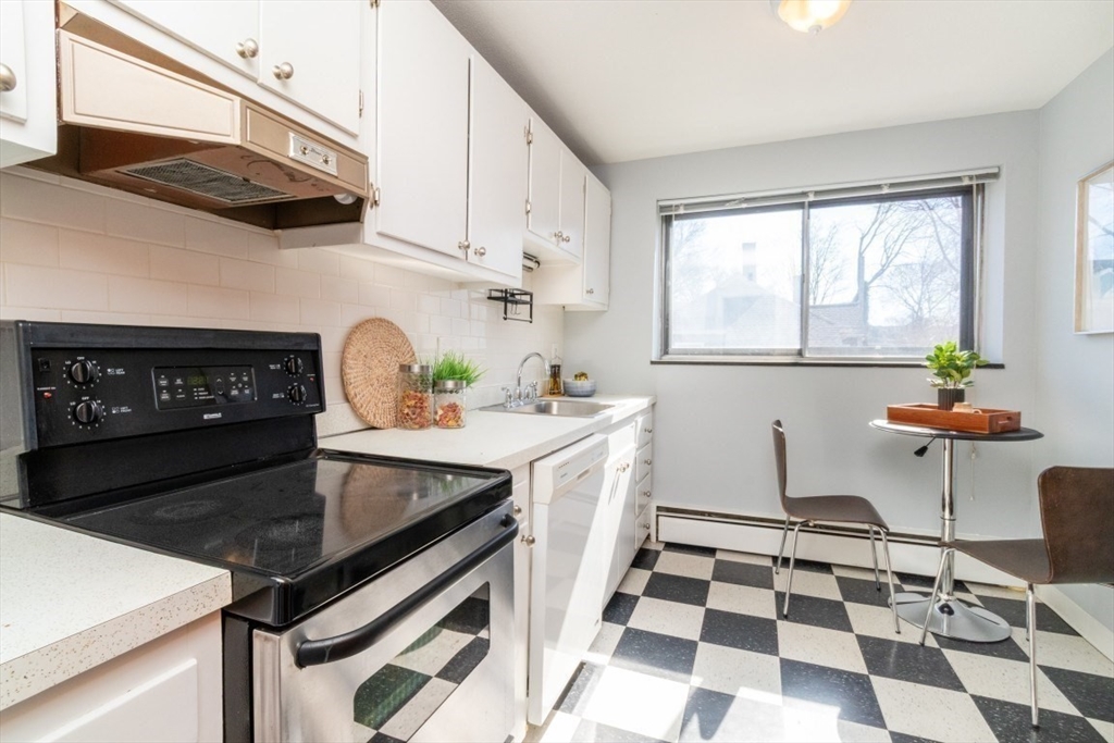 57 St Paul Street, Unit 19 Brookline, MA 02446 - Photo 8 of 23 a kitchen with a sink a stove and a microwave