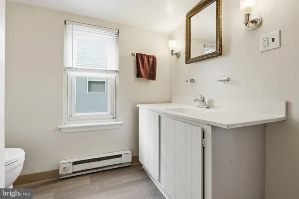 a bathroom with a sink a toilet and mirror