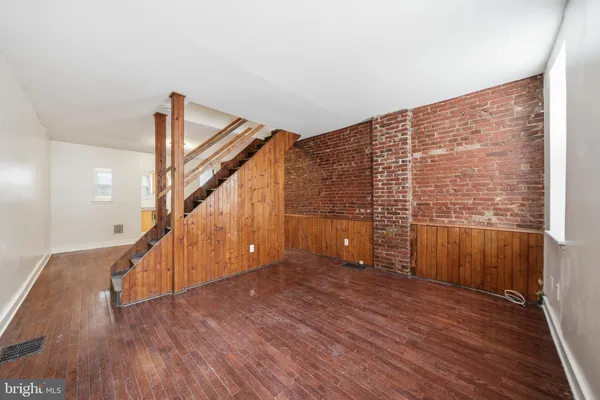 a view of an entryway with wooden floor