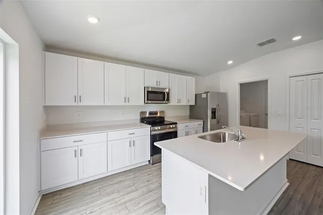 a kitchen with a sink stove and refrigerator