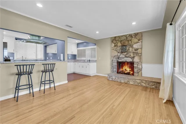 a view of kitchen with granite countertop cabinets and refrigerator