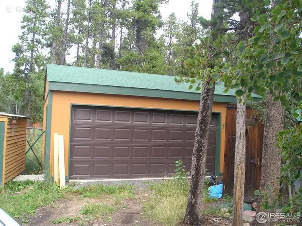 a front view of a house with a tree
