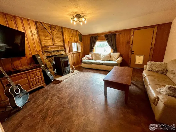 a bedroom with furniture and a flat screen tv