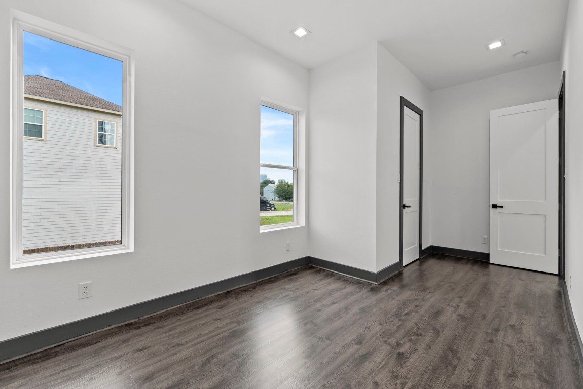 3118 Clay Street Houston, TX 77003 - Photo 14 of 32 an empty room with wooden floor and windows