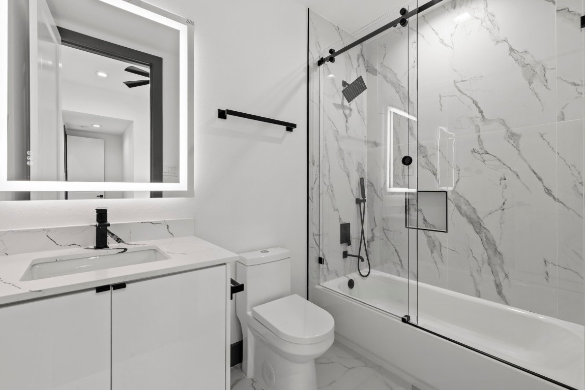 3118 Clay Street Houston, TX 77003 - Photo 25 of 32 a bathroom with a granite countertop sink toilet and shower