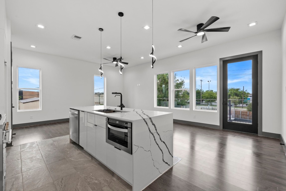 3118 Clay Street Houston, TX 77003 - Photo 9 of 32 a view of a kitchen with a sink wooden floor and a large window