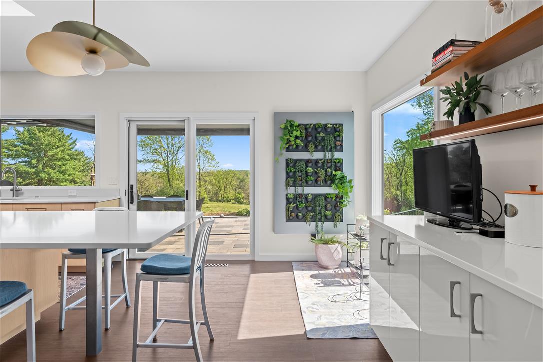 1506 Pleasant View Road Coopersburg, PA 18036 - Photo 24 of 97 A contemporary kitchen space boasts gleaming countertops and panoramic outdoor views through large windows.