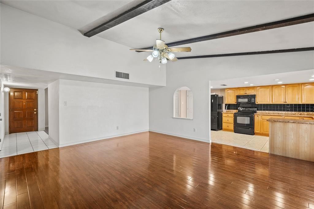 5619 Pine Row Street Houston, TX 77049 - Photo 4 of 8 wooden floor in an empty room with a window