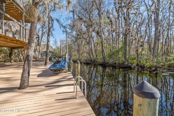 a view of a deck with furniture and wooden floor