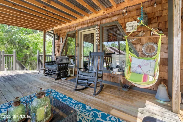 a view of porch with furniture and wooden floor
