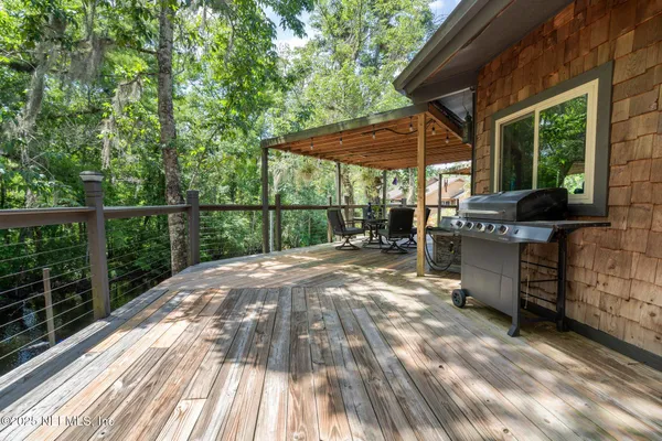 a bedroom with a bed mirror on desk and a window