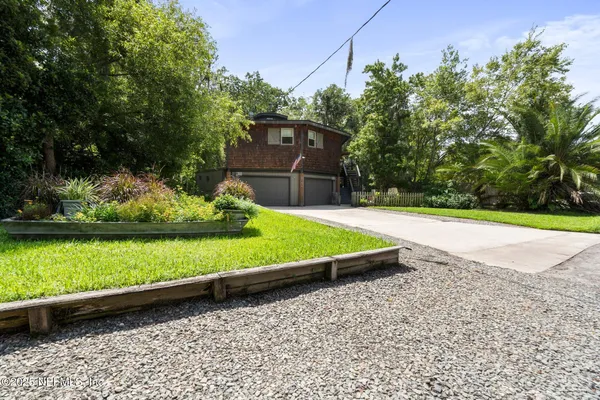 a view of a backyard with wooden fence
