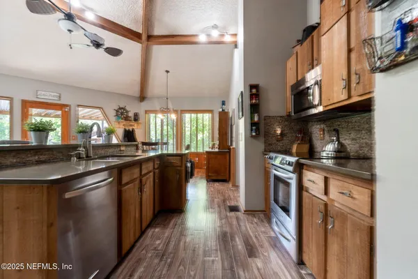 a bathroom with a granite countertop sink and a large mirror