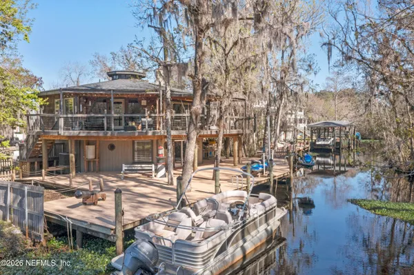a view of a lake with wooden stairs and bench next to a lake