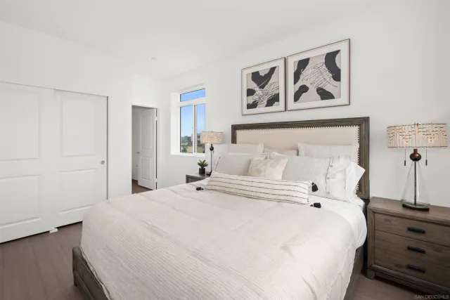 a bedroom with bed and wall painting