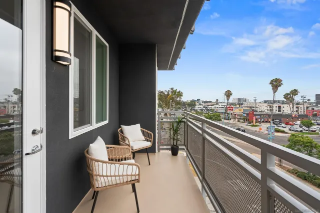 a balcony with table and chairs