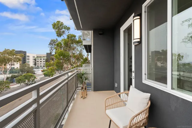 a living room with furniture kitchen view and a refrigerator