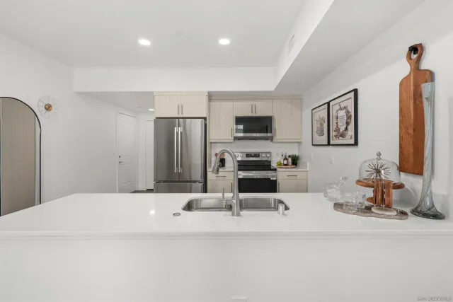 a kitchen with stainless steel appliances a refrigerator and a stove top oven