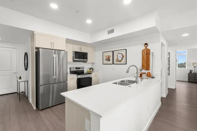 a kitchen with stainless steel appliances a refrigerator and a stove top oven