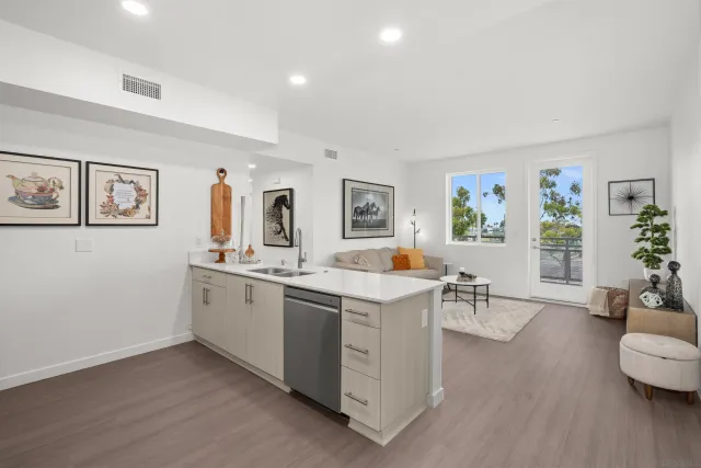 a view of living room with furniture and wooden floor