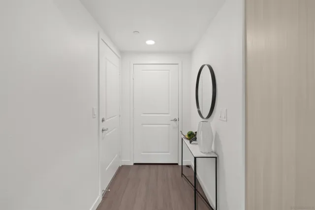 a view of a room with wooden floor