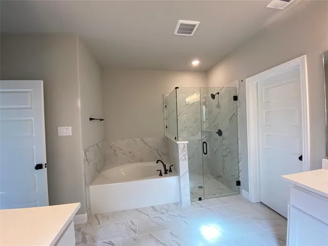 a bathroom with a sink a toilet a mirror and shower