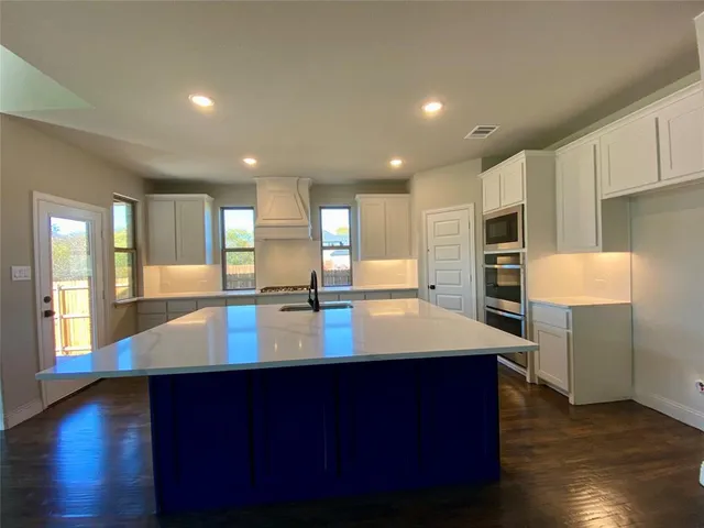 a room with wooden floors and pool table