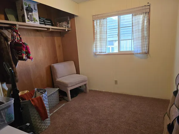 a view of a room with furniture and a window