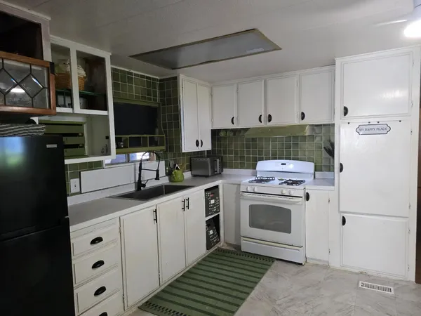 a kitchen with cabinets and white appliances