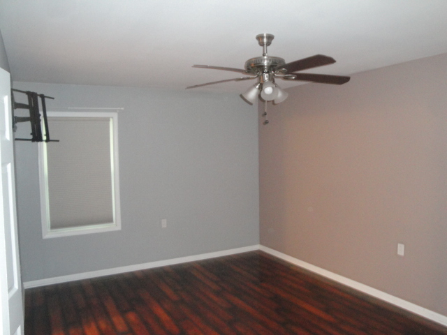 4515 Ashley Drive McHenry, IL 60050 - Photo 12 of 28 a view of a room with wooden floor and fan