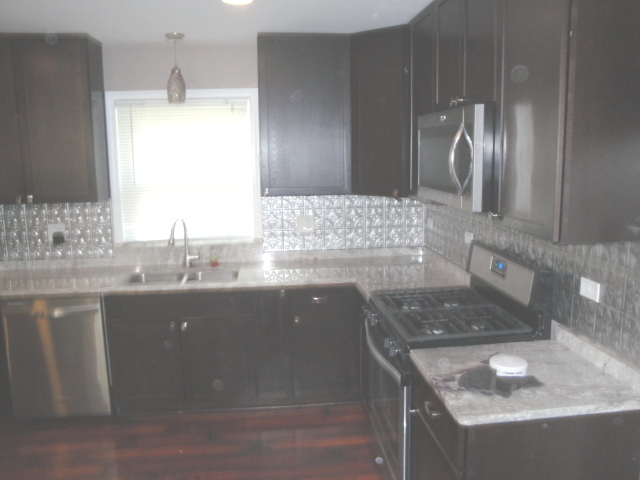 4515 Ashley Drive McHenry, IL 60050 - Photo 16 of 28 a bathroom with a granite countertop sink a vanity and mirror