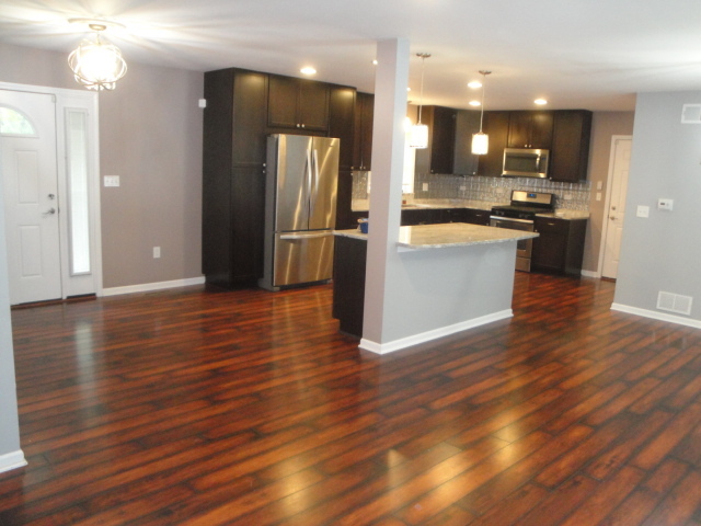 4515 Ashley Drive McHenry, IL 60050 - Photo 7 of 28 a view of a kitchen with refrigerator and wooden floor