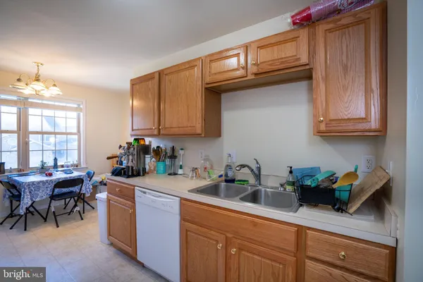 a kitchen with granite countertop a sink a stove and cabinets