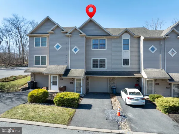 a front view of a house with parking space