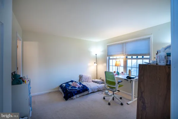 a room with furniture a rug toys and a window