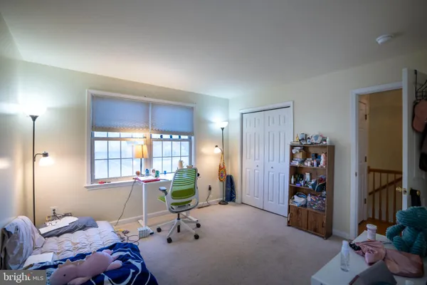 a bedroom with furniture and a window