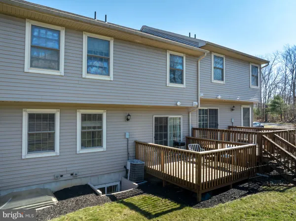 a front view of house with deck and furniture