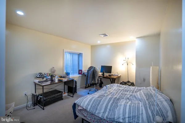 a bed room with a bed and a chair