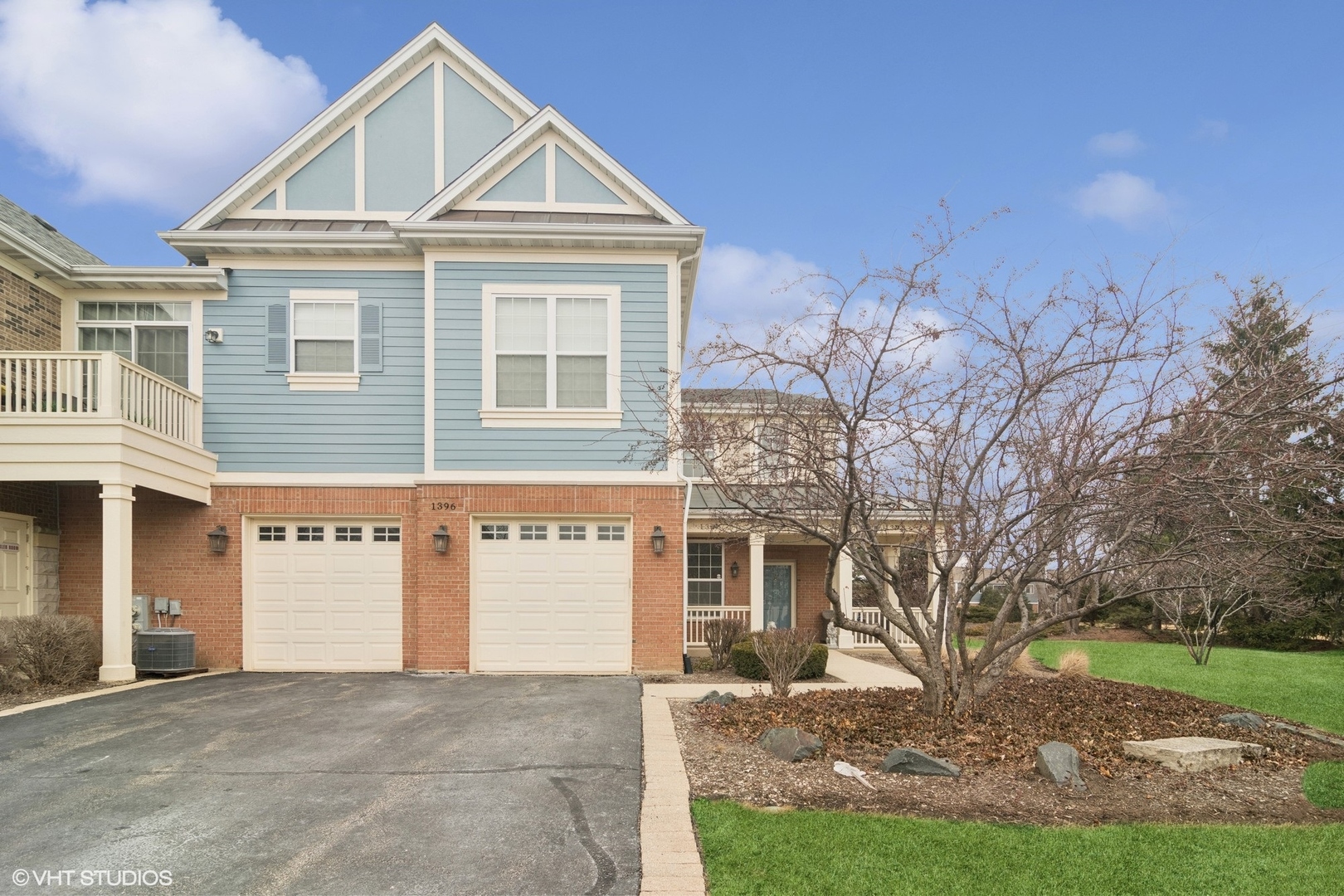 1396 Scarboro Road, Unit 1201 Schaumburg, IL 60193 - Photo 1 of 20 a front view of a house with a yard and garage