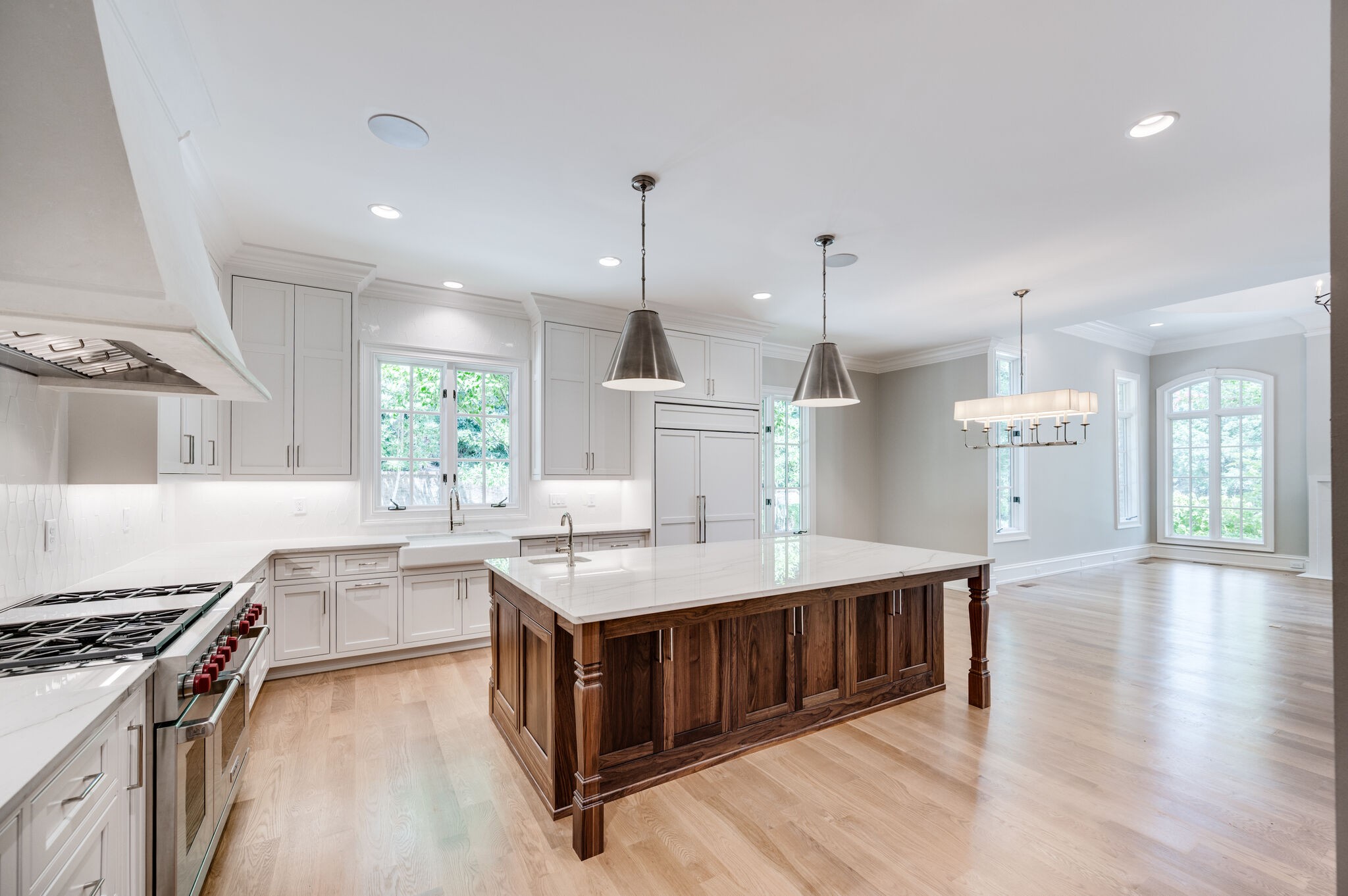1073 Vaughn Crest Boulevard Franklin, TN 37069 - Photo 11 of 70 a large kitchen with kitchen island a stove a sink a center island and windows